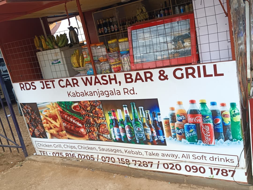 Roadside kiosk for RDS Jet Car Wash, Bar & Grill with a food and drink sign.
